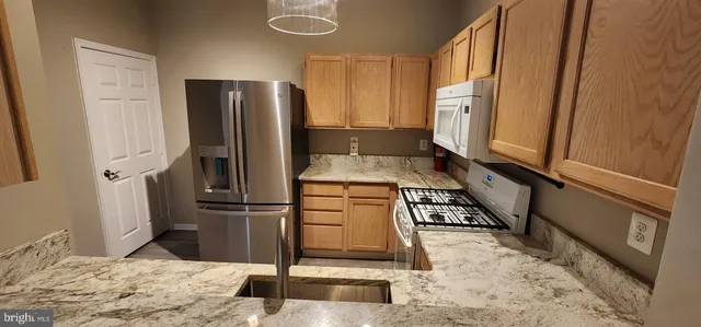 a kitchen with a refrigerator sink and stove