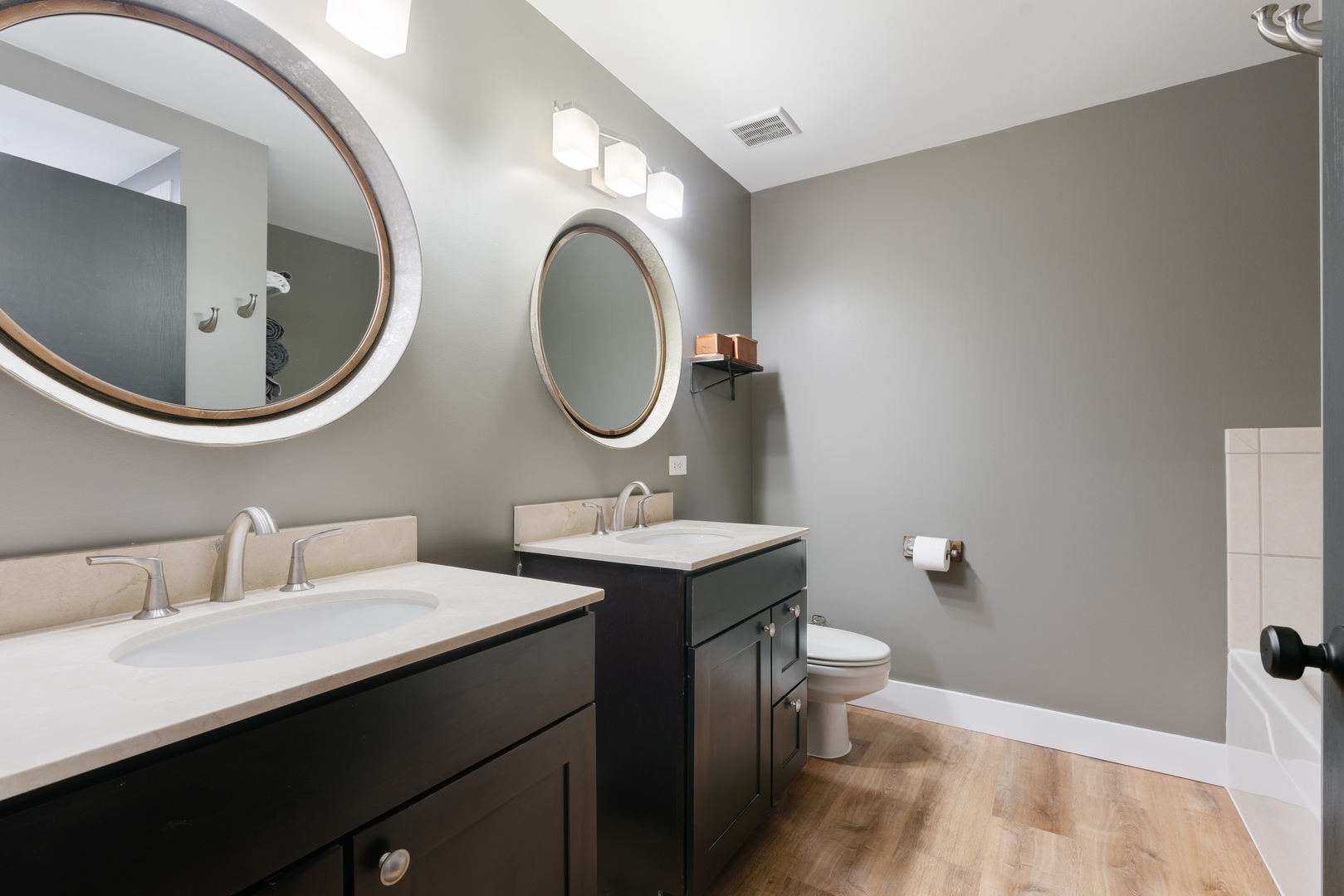 1250 South Indiana Avenue, Unit 101 Chicago, IL 60605 - Photo 12 of 16 a bathroom with a toilet a sink and mirror