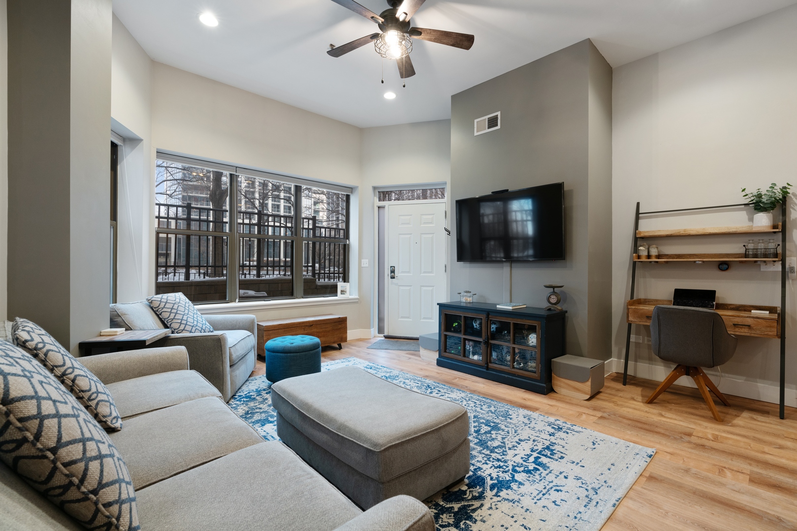 1250 South Indiana Avenue, Unit 101 Chicago, IL 60605 - Photo 4 of 16 a living room with furniture and a flat screen tv