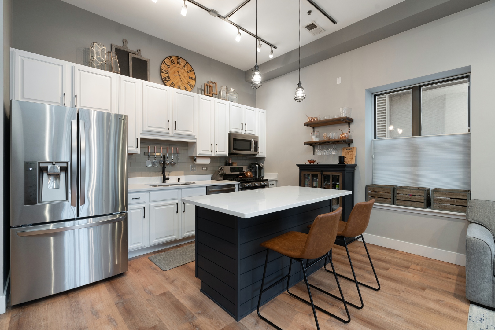 1250 South Indiana Avenue, Unit 101 Chicago, IL 60605 - Photo 7 of 16 a kitchen with stainless steel appliances a sink a stove a refrigerator cabinets and a dining table