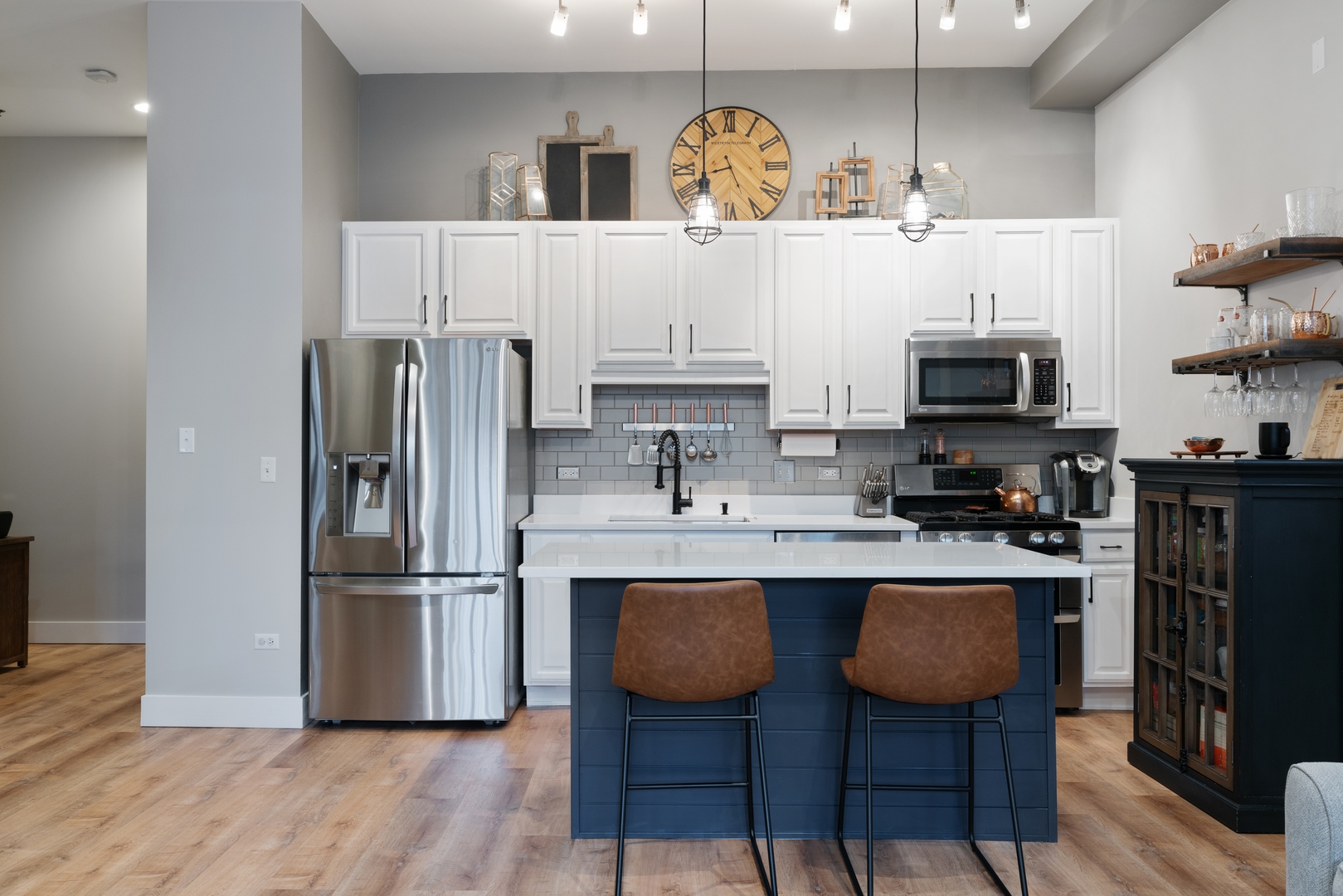 1250 South Indiana Avenue, Unit 101 Chicago, IL 60605 - Photo 8 of 16 a kitchen with stainless steel appliances a refrigerator a stove a sink and chairs