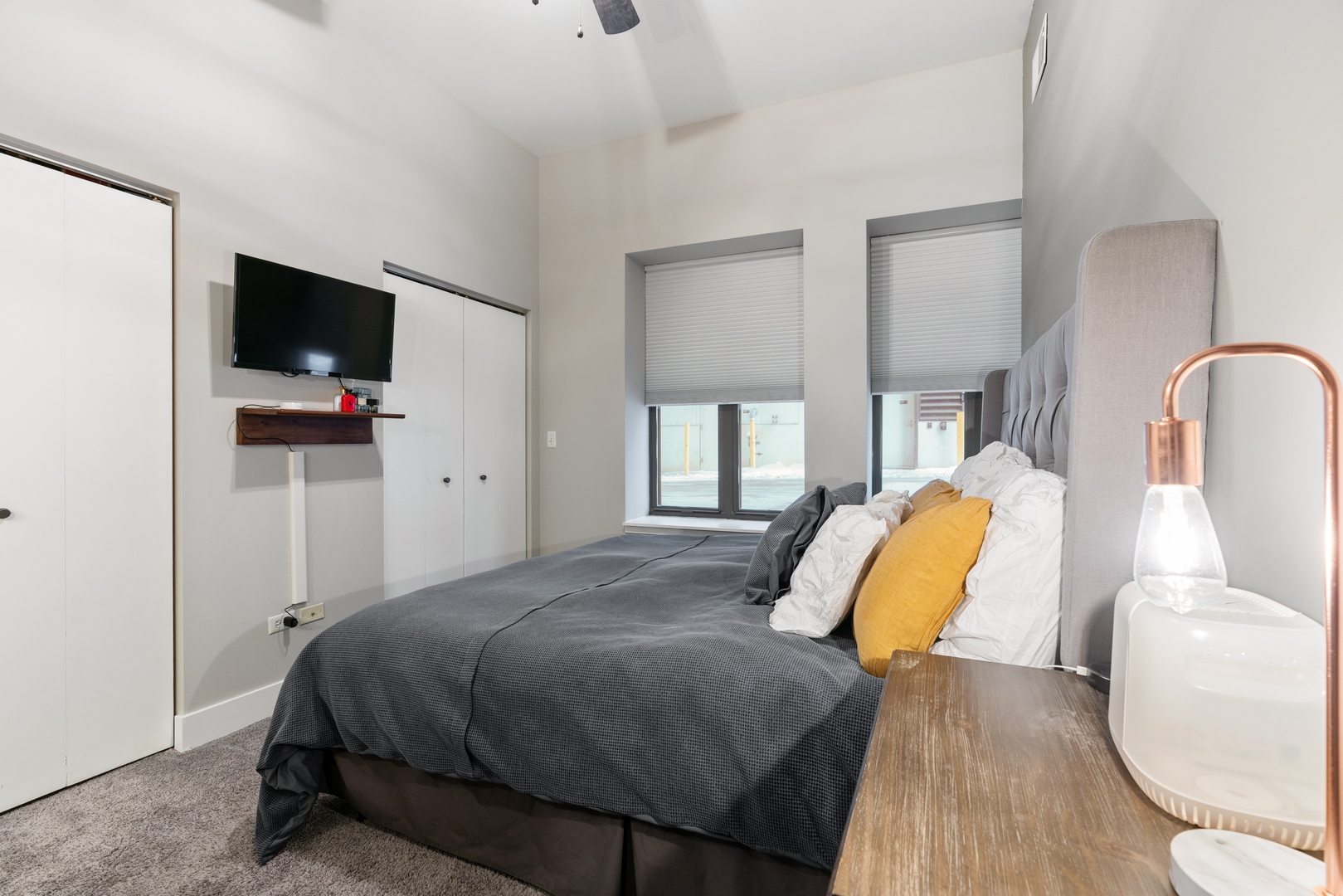 1250 South Indiana Avenue, Unit 101 Chicago, IL 60605 - Photo 9 of 16 a bedroom with a bed and a flat screen tv