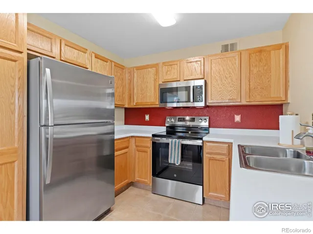 a kitchen with a table chairs and white cabinets
