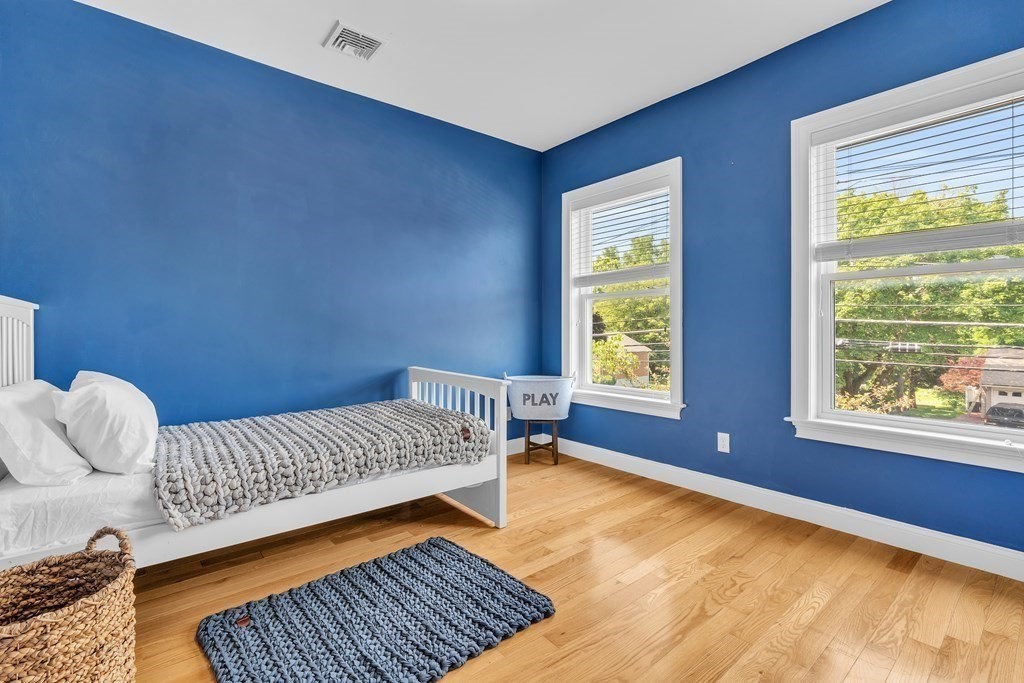 138 Webster Street Needham, MA 02494 - Photo 17 of 29 a bedroom with a bed and wooden floor