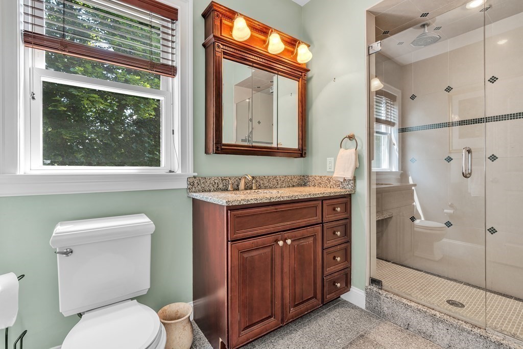 138 Webster Street Needham, MA 02494 - Photo 26 of 29 a bathroom with a granite countertop toilet sink and mirror