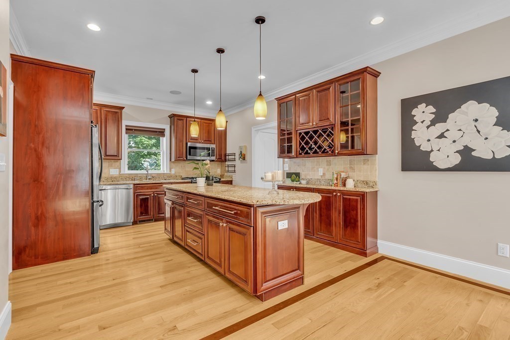 138 Webster Street Needham, MA 02494 - Photo 4 of 29 a kitchen with stainless steel appliances granite countertop a stove a sink and a refrigerator