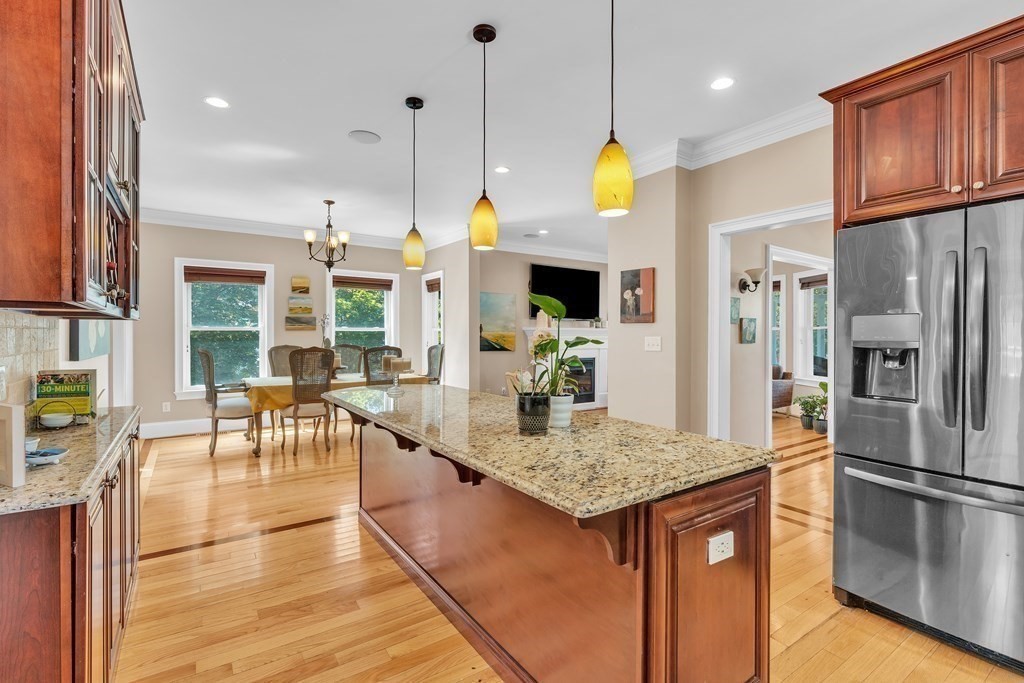 138 Webster Street Needham, MA 02494 - Photo 5 of 29 a kitchen with stainless steel appliances granite countertop a stove kitchen island a refrigerator and a view of living room