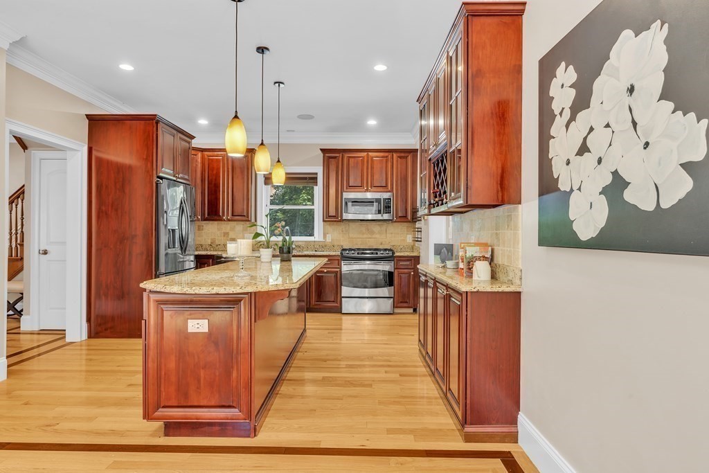 138 Webster Street Needham, MA 02494 - Photo 8 of 29 a kitchen with stainless steel appliances granite countertop a stove a sink and a refrigerator