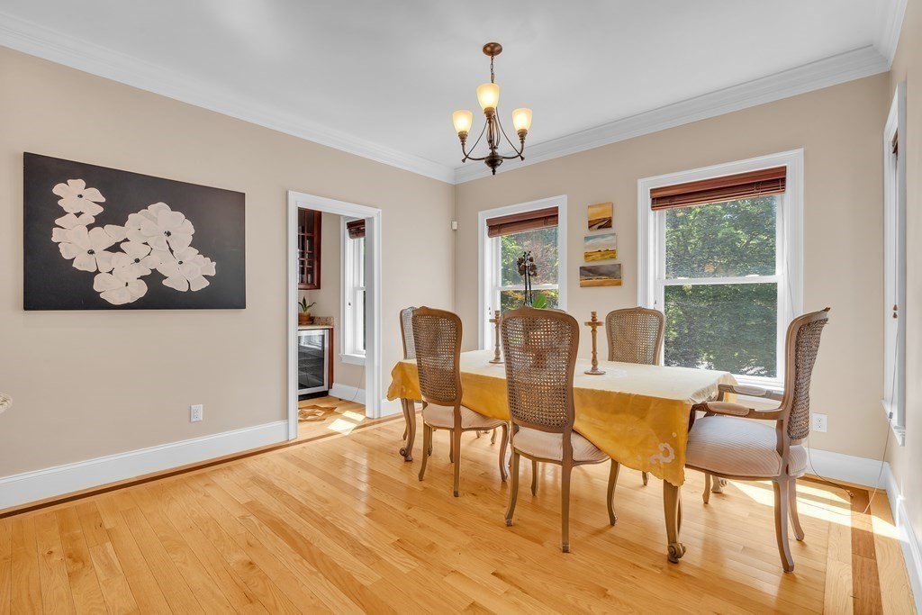 138 Webster Street Needham, MA 02494 - Photo 10 of 29 a view of a dining room with furniture a chandelier and wooden floor