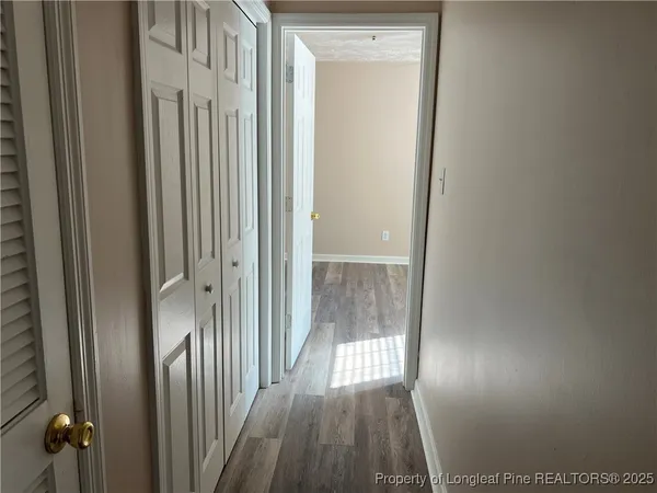 wooden floor fireplace and windows in an empty room