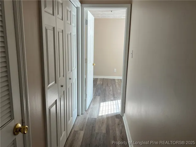 wooden floor fireplace and windows in an empty room
