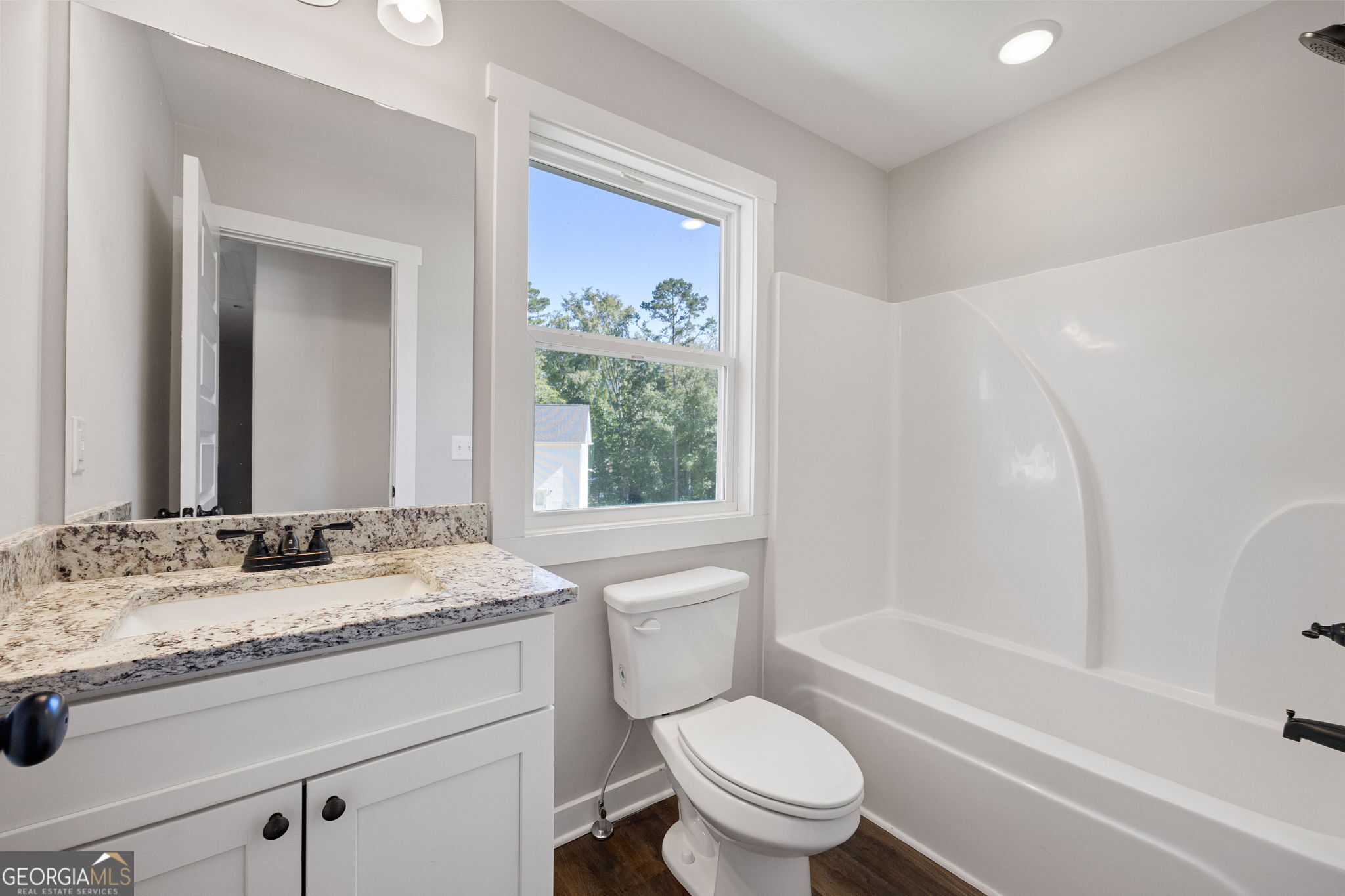 205 Pinecrest Road Cedartown, GA 30125 - Photo 22 of 27 a bathroom with a granite countertop toilet sink and mirror with bathtub