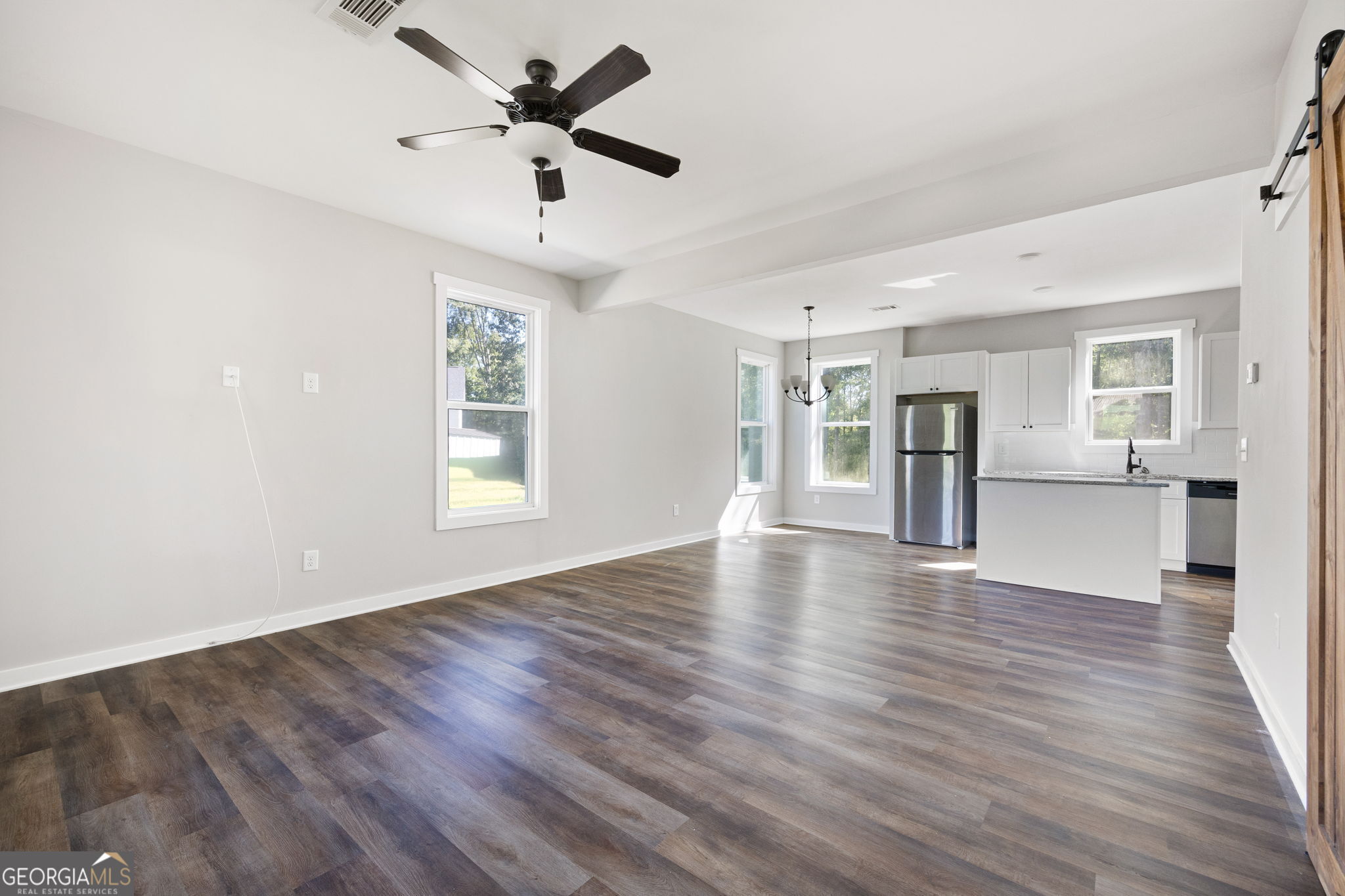 205 Pinecrest Road Cedartown, GA 30125 - Photo 8 of 27 a view of an empty room with window and wooden floor