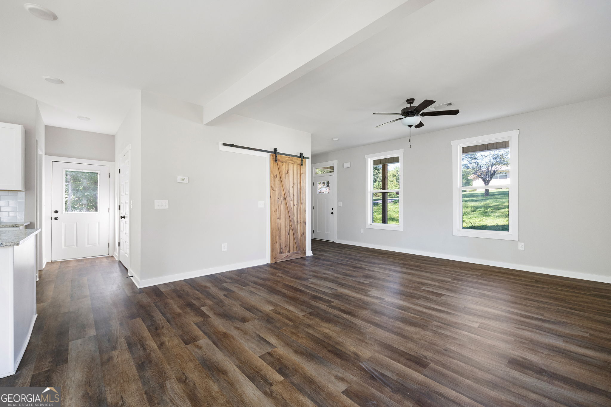 205 Pinecrest Road Cedartown, GA 30125 - Photo 9 of 27 a view of an empty room with wooden floor and a window