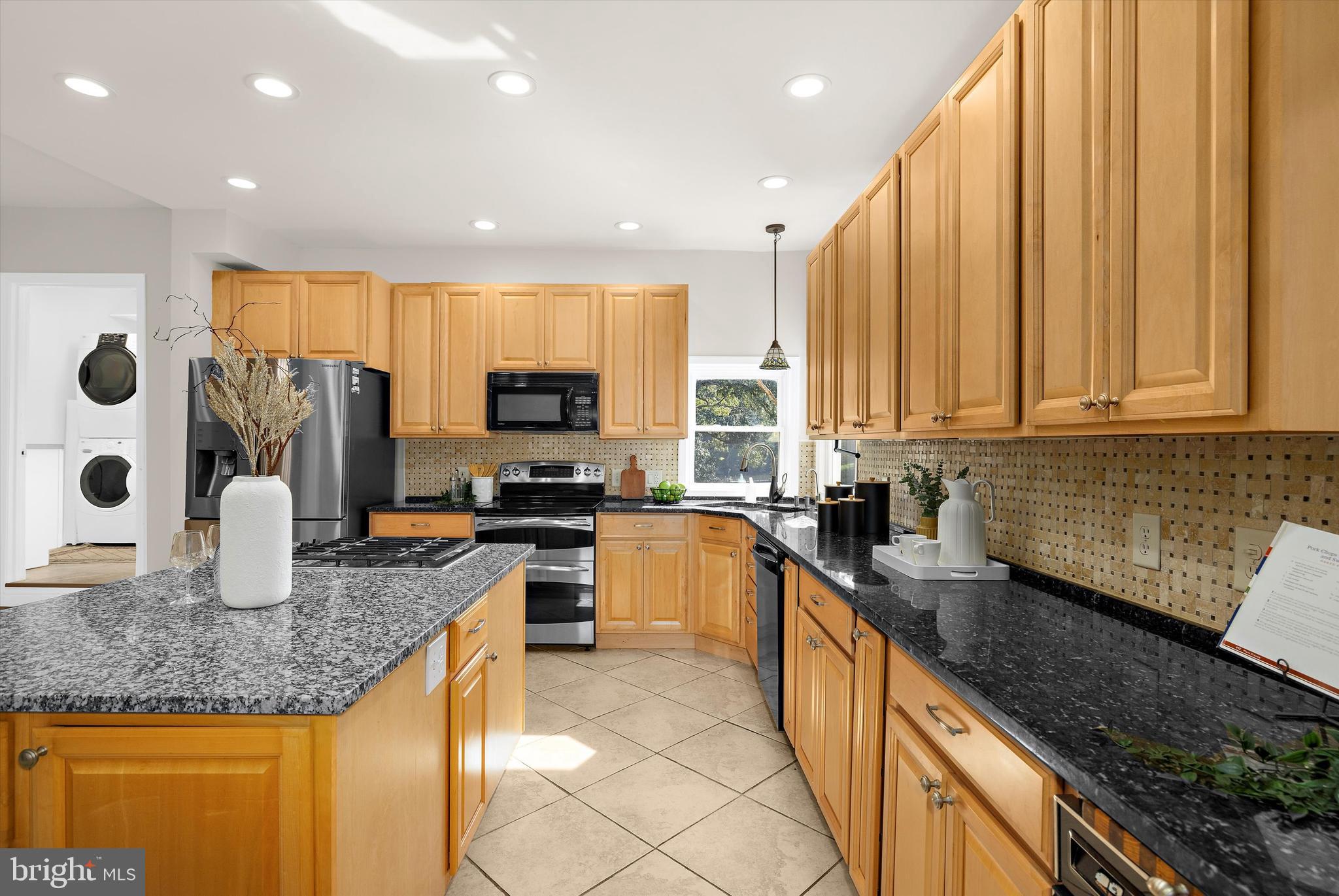 619 Riverside Drive Pasadena, MD 21122 - Photo 16 of 84 a kitchen with stainless steel appliances granite countertop a sink a stove and cabinets