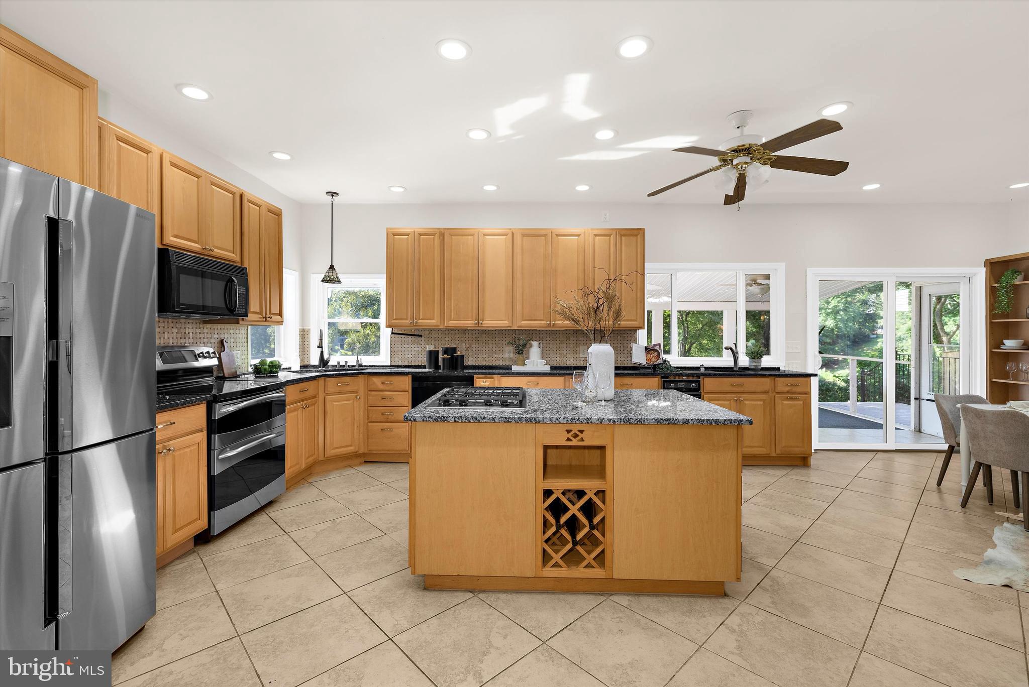 619 Riverside Drive Pasadena, MD 21122 - Photo 18 of 84 a large kitchen with kitchen island a counter top space appliances and cabinets