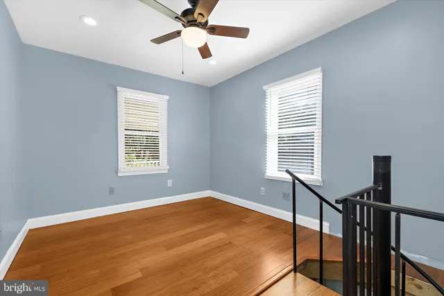 a view of a roof deck with wooden floor and fence