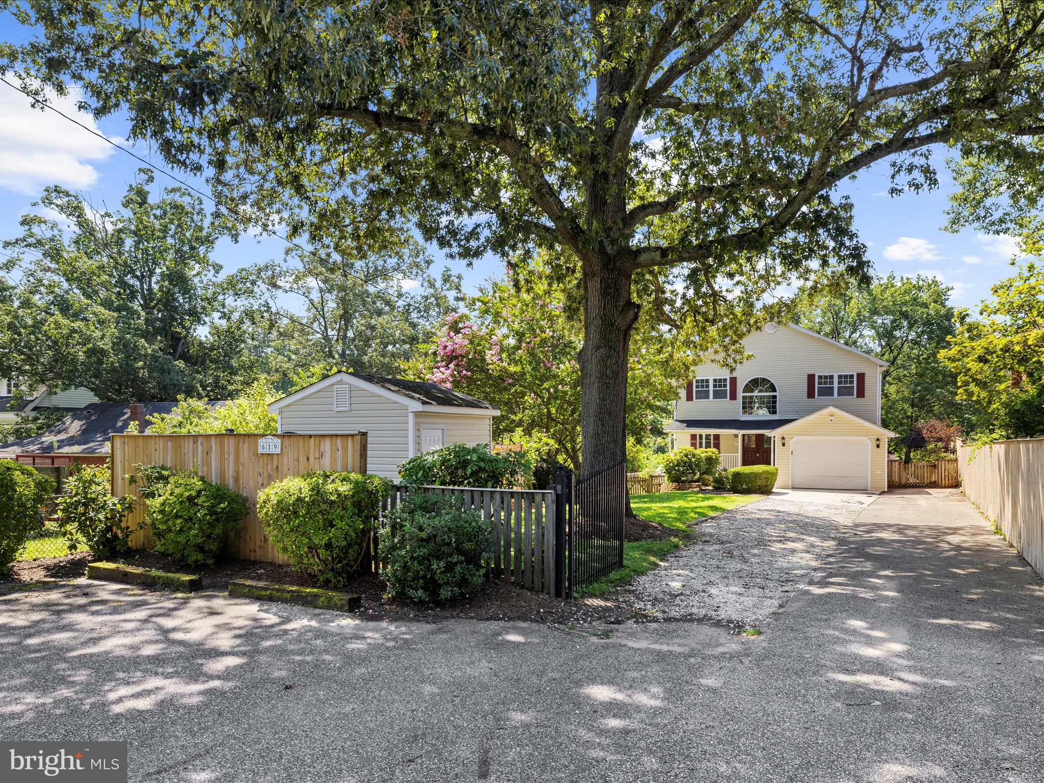 619 Riverside Drive Pasadena, MD 21122 - Photo 3 of 84 a view of a house with a small yard and large tree