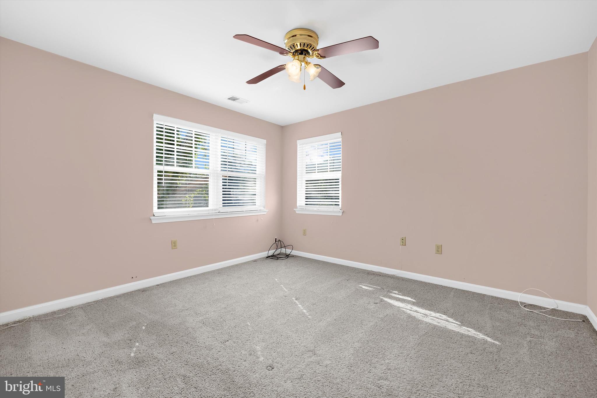619 Riverside Drive Pasadena, MD 21122 - Photo 39 of 84 an empty room with windows and chandelier fan