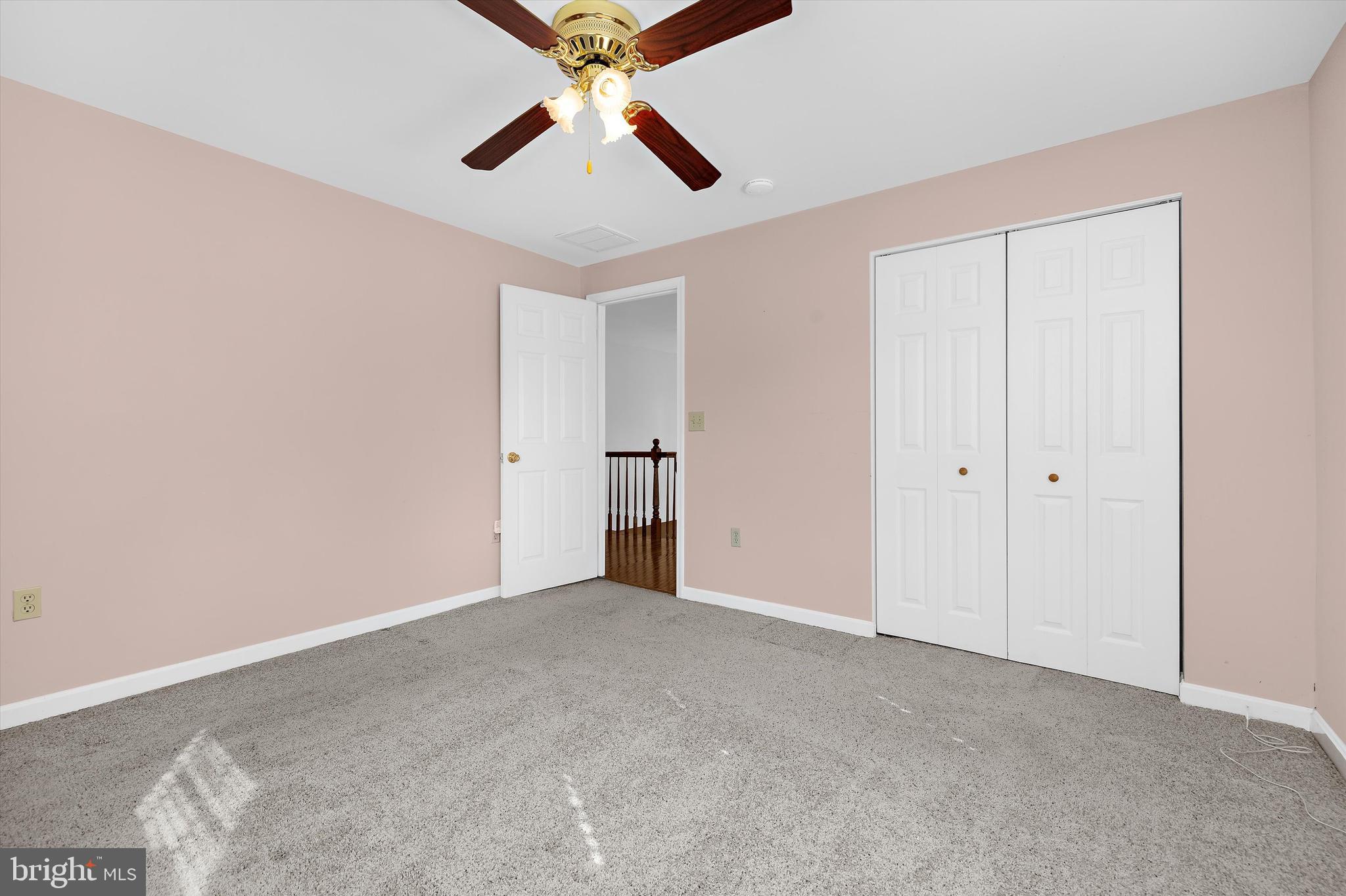 619 Riverside Drive Pasadena, MD 21122 - Photo 40 of 84 an empty room with closet and a chandelier fan