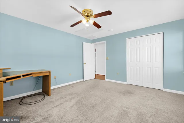 an aerial view of residential houses with outdoor space and trees