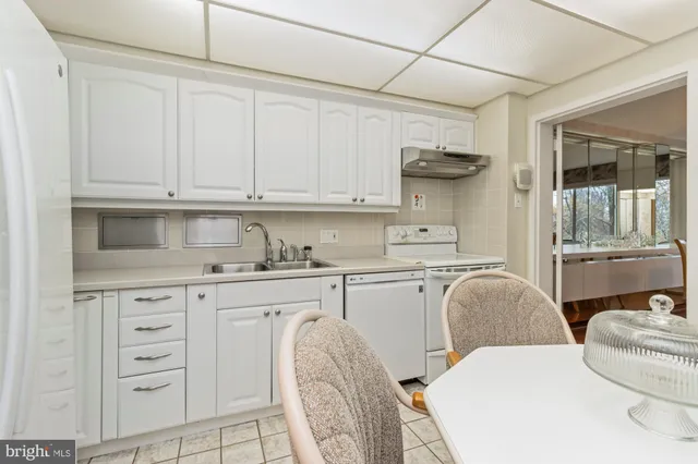 a dining room with furniture and a chandelier