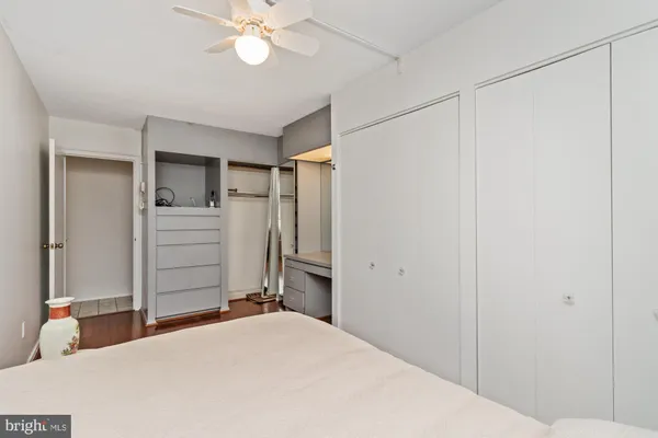a bedroom with a large bed and wooden floor