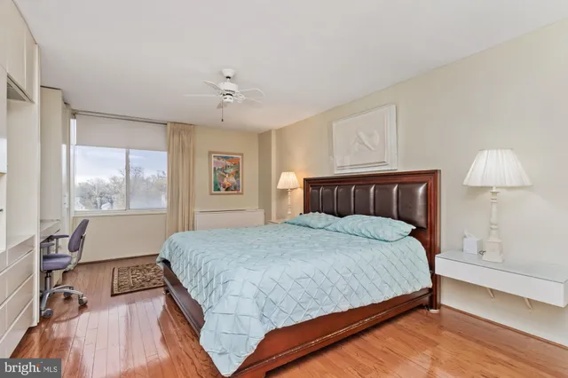 a bedroom with a bed cabinets and window