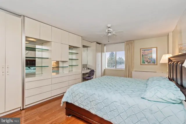 a spacious bedroom with a bed and a chandelier