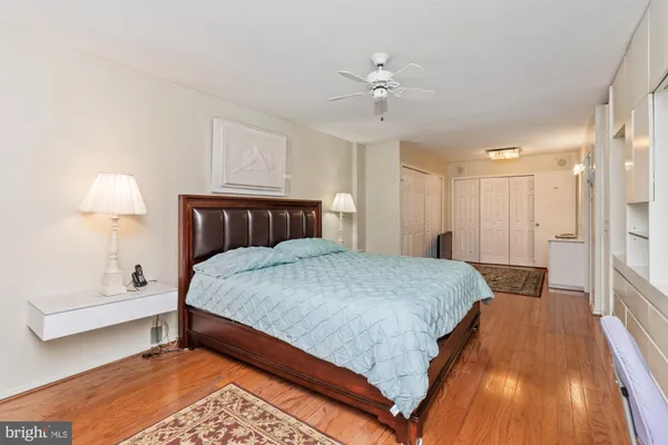 a spacious bedroom with a bed a table and chair