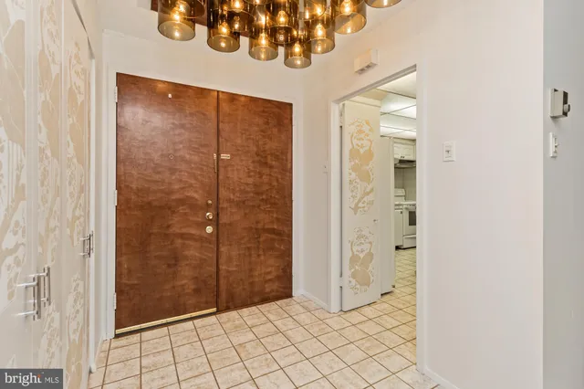 a kitchen with stainless steel appliances white cabinets and wooden floor