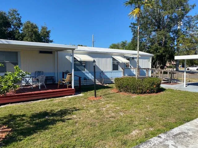 a view of a house with a yard balcony and sitting area