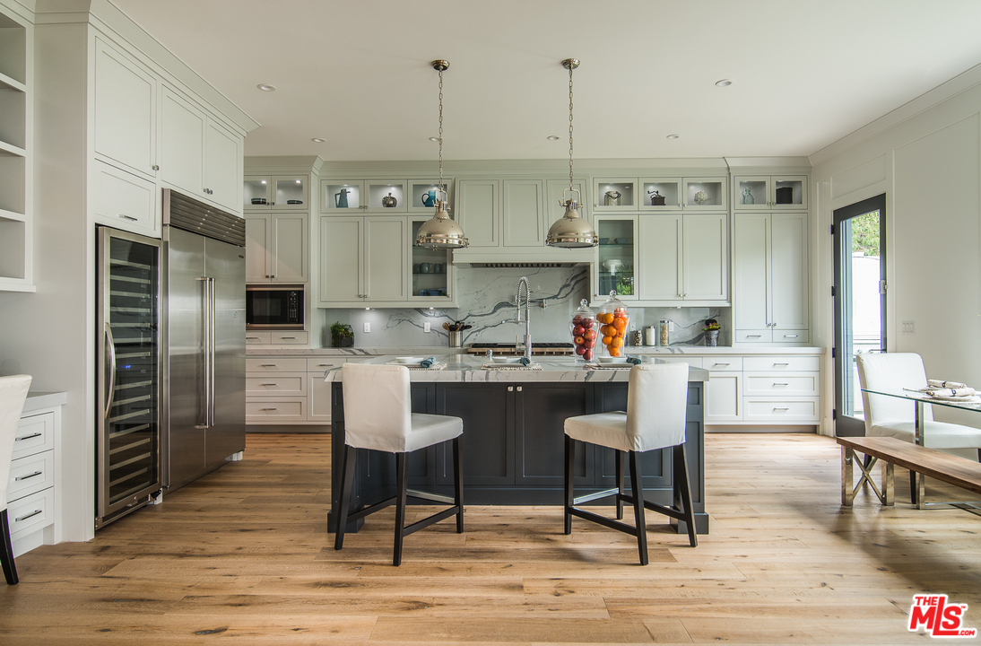 4425 Beck Avenue Studio City, CA 91602 - Photo 18 of 48 a kitchen with stainless steel appliances kitchen island granite countertop a refrigerator and wooden cabinets
