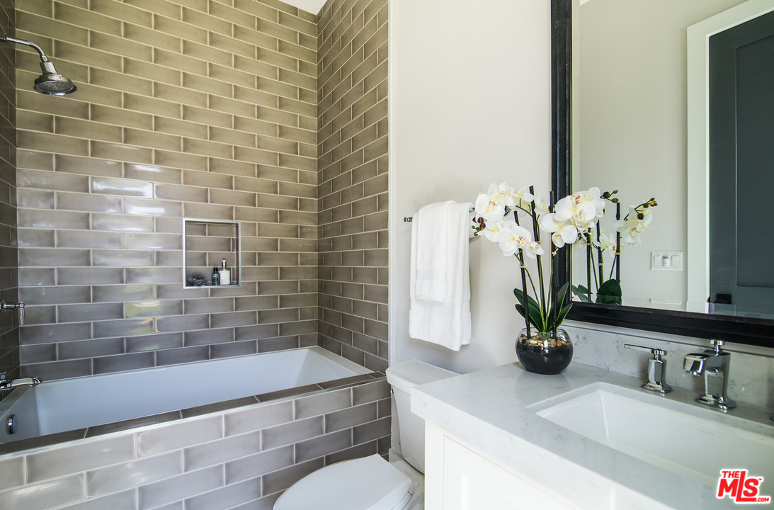 4425 Beck Avenue Studio City, CA 91602 - Photo 24 of 48 a bathroom with a granite countertop sink a toilet and mirror