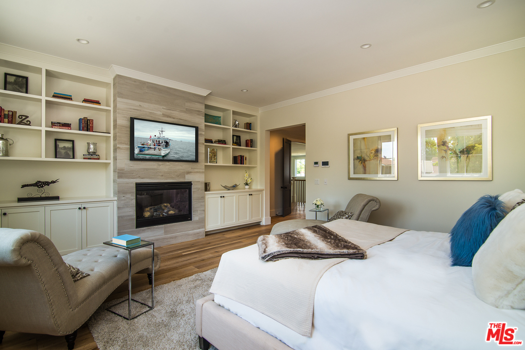 4425 Beck Avenue Studio City, CA 91602 - Photo 29 of 48 a bedroom with a bed and a fireplace