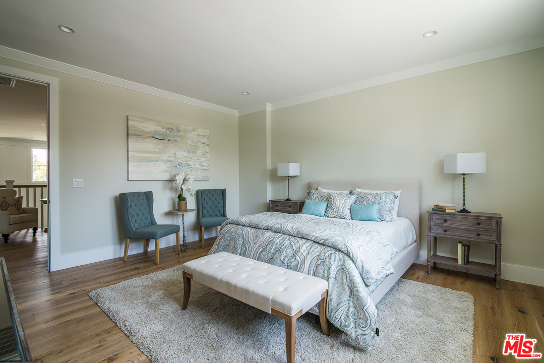 4425 Beck Avenue Studio City, CA 91602 - Photo 35 of 48 a bedroom with a bed a chair and a fireplace