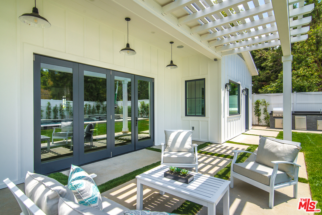 4425 Beck Avenue Studio City, CA 91602 - Photo 41 of 48 a living room with patio furniture and a floor to ceiling window