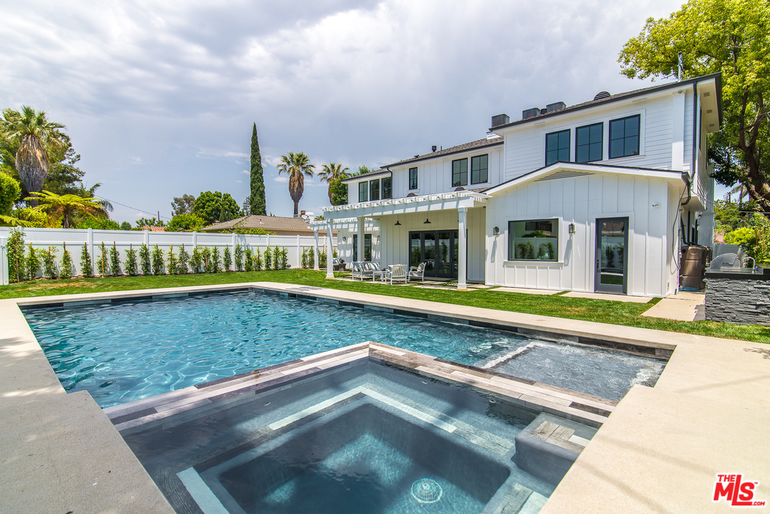 4425 Beck Avenue Studio City, CA 91602 - Photo 44 of 48 a view of swimming pool with outdoor seating and house in the background