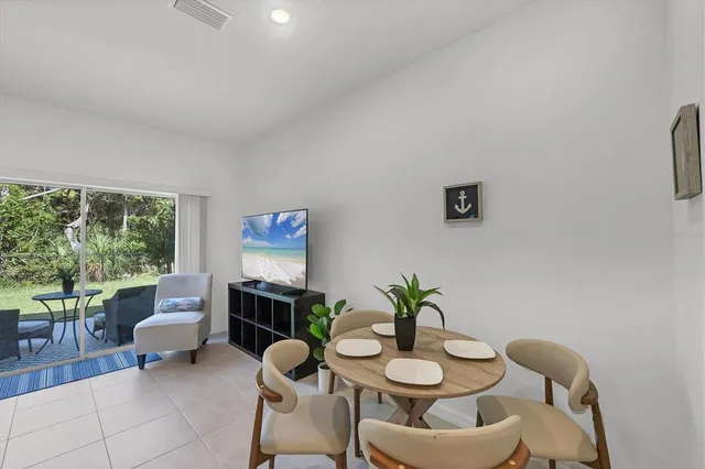 a bedroom with a bed table and a window