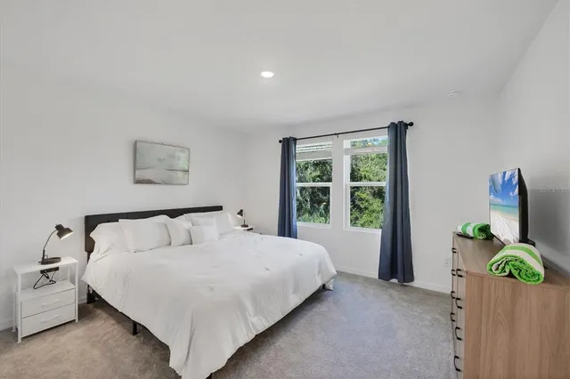 a bedroom with a bed and a dresser