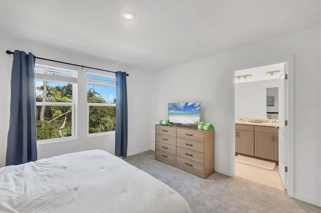 a bathroom with a double vanity sink mirror and toilet