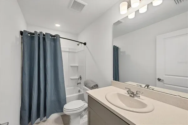 a bedroom with a bed and chair