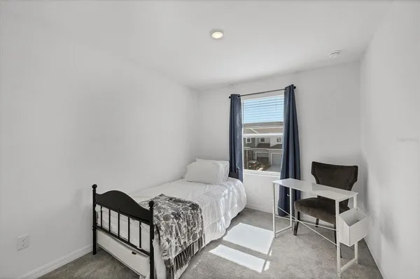 a bedroom with a bed and window