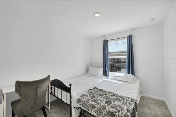 a bathroom with a sink and mirror with bathtub