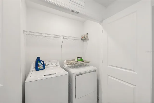 a view of a table and chairs in backyard of the house