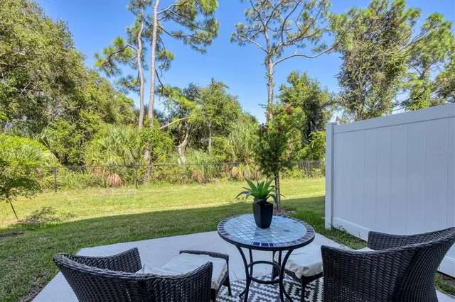 a view of house with outdoor seating and yard