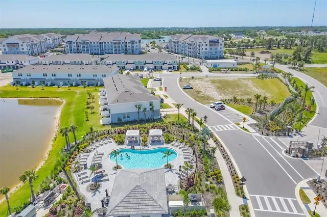an aerial view of a house with a swimming pool outdoor seating and yard