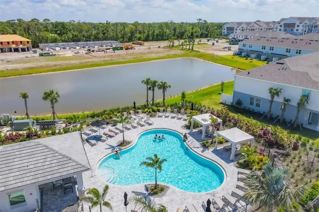 an aerial view of residential houses with outdoor space