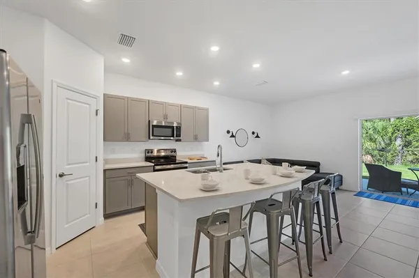 a kitchen that has a sink and a stove top oven