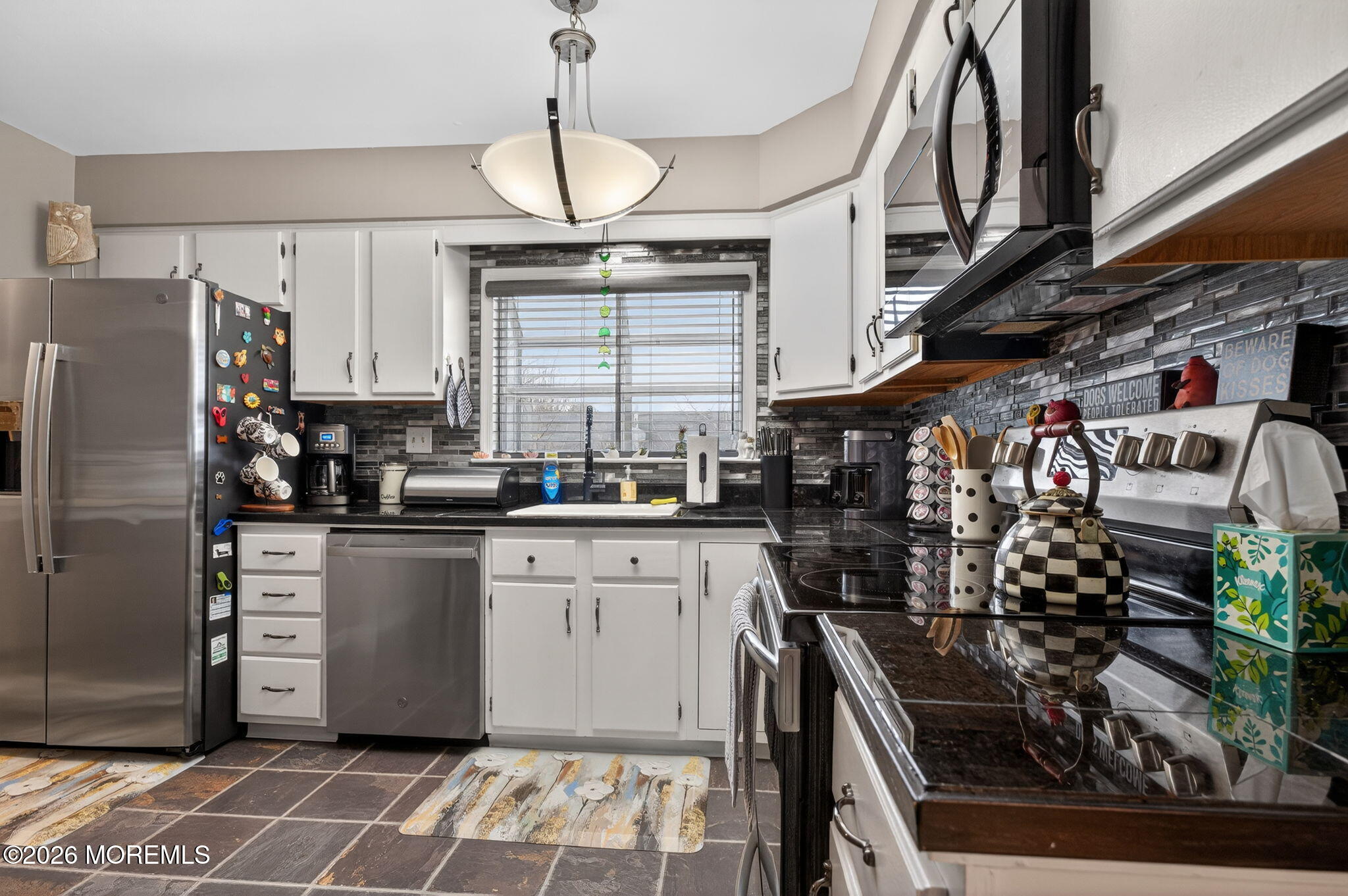 5 Scarborough Road, Unit D Monroe Township, NJ 08831 - Photo 10 of 28 a kitchen with stainless steel appliances granite countertop a stove a sink and a refrigerator